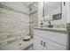 Updated bathroom with gray wood-look tile, glass shower, and granite vanity at 1092 Donnelly Sw Ave, Atlanta, GA 30310