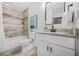 Beautiful bathroom featuring tiled shower, granite vanity, tile floors, and modern fixtures at 1092 Donnelly Sw Ave, Atlanta, GA 30310