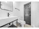 Modern bathroom featuring a sleek sink, toilet and hardware with white subway tile at 1092 Donnelly Sw Ave, Atlanta, GA 30310