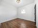 Bright bedroom with hardwood floors, white walls, window and modern light fixture at 1092 Donnelly Sw Ave, Atlanta, GA 30310