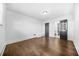 Bedroom with hardwood floors, white walls, black door, and natural light at 1092 Donnelly Sw Ave, Atlanta, GA 30310