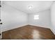 Bedroom featuring new hardwood floors, white walls, and modern light fixture at 1092 Donnelly Sw Ave, Atlanta, GA 30310