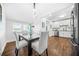 Elegant dining room with modern light fixture, wood floors adjacent to the updated kitchen at 1092 Donnelly Sw Ave, Atlanta, GA 30310