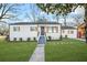 Recently renovated white house with gray roof, wooden shutters, and landscaped lawn at 1092 Donnelly Sw Ave, Atlanta, GA 30310