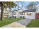 White house with gray roof and a spacious driveway, and wooden shutters at 1092 Donnelly Sw Ave, Atlanta, GA 30310