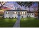 Charming white house with gray roof, wooden shutters, and landscaped lawn at 1092 Donnelly Sw Ave, Atlanta, GA 30310