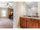 Bathroom with granite vanity, large mirror, and access to bedroom at 1731 Panorama Dr, Locust Grove, GA 30248