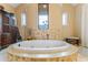 Luxurious bathroom with oval jetted tub and tile surround at 1731 Panorama Dr, Locust Grove, GA 30248