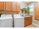 Laundry room with washer, dryer, cabinets, and utility sink at 1731 Panorama Dr, Locust Grove, GA 30248