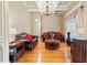 Spacious living room with hardwood floors, leather sofas, and a large window at 1731 Panorama Dr, Locust Grove, GA 30248