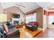 Bright living room featuring hardwood floors, fireplace, and comfortable seating at 1731 Panorama Dr, Locust Grove, GA 30248