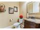Convenient powder room with granite vanity and decorative mirror at 1731 Panorama Dr, Locust Grove, GA 30248