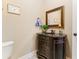 Small powder room with dark vanity and granite countertop at 1731 Panorama Dr, Locust Grove, GA 30248