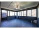 Sunroom with dark gray walls, tile floor, ceiling fan, and screened door at 540 Flint Ridge Ct, Jonesboro, GA 30238
