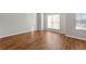 Bright bedroom featuring hardwood floors, gray walls and natural light from two windows at 5615 Strathmoor Mnr, Lithonia, GA 30058