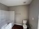 Clean bathroom with tub shower, toilet and vinyl floor at 6403 Walnut Way, Union City, GA 30291
