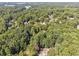 Aerial view of neighborhood with lush trees and lake at 2505 Ridgehurst Dr, Buford, GA 30518