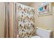 Small bathroom with shower/tub combo and colorful curtain at 2505 Ridgehurst Dr, Buford, GA 30518