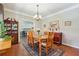 Elegant dining room with hardwood floors, chandelier, and wood table at 2505 Ridgehurst Dr, Buford, GA 30518