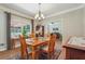 Spacious dining room features hardwood floors, a table for four and natural light at 2505 Ridgehurst Dr, Buford, GA 30518