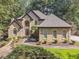 Two-story house with stucco exterior, landscaping, and a paved driveway at 2505 Ridgehurst Dr, Buford, GA 30518