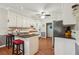 Galley kitchen with granite countertops, white cabinets, and hardwood floors at 2505 Ridgehurst Dr, Buford, GA 30518