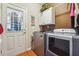 Convenient laundry room includes washer, dryer, and exterior access at 2505 Ridgehurst Dr, Buford, GA 30518