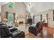 Spacious living room with hardwood floors, fireplace, and large windows at 2505 Ridgehurst Dr, Buford, GA 30518