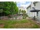 A back yard of a house with green grass, garden area and a patio and sitting area at 42 Millstone Gln, Dallas, GA 30157
