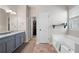 A bathroom featuring tile floors, a large soaking tub and double vanity at 42 Millstone Gln, Dallas, GA 30157
