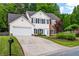 Charming two-story home features a well-maintained lawn and attached two-car garage at 42 Millstone Gln, Dallas, GA 30157