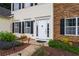 Charming two-story home featuring a welcoming front entrance with stone accents and manicured landscaping at 42 Millstone Gln, Dallas, GA 30157