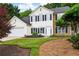 Inviting two-story home with a manicured lawn, attached garage, and charming stone accents at 42 Millstone Gln, Dallas, GA 30157
