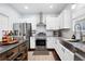 Updated kitchen with stainless steel appliances, granite counters, and ample cabinet space at 42 Millstone Gln, Dallas, GA 30157