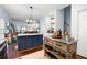 Open kitchen layout with island, modern lighting, and views to the living room at 42 Millstone Gln, Dallas, GA 30157