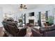 Bright living room with a cozy fireplace, plush leather furniture, and dark wood floors at 42 Millstone Gln, Dallas, GA 30157