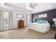 Main bedroom suite featuring a tray ceiling, neutral carpeting, and windows providing lots of light at 42 Millstone Gln, Dallas, GA 30157