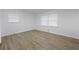 Bright bedroom features wood-look flooring and large windows for natural light at 132 Arnold Pl, Jonesboro, GA 30236