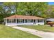 Attractive single-story house with a well-maintained lawn and a long driveway at 132 Arnold Pl, Jonesboro, GA 30236