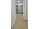Hallway view towards a kitchen, featuring stainless steel appliances and modern design at 132 Arnold Pl, Jonesboro, GA 30236