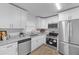 Updated kitchen featuring stainless steel appliances, granite countertops, and ample cabinet space at 132 Arnold Pl, Jonesboro, GA 30236
