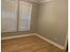 Bright bedroom with two windows and wood floors at 1405 Aramore Se Dr, Conyers, GA 30013