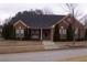 Brick ranch house with a landscaped yard and attached garage at 1405 Aramore Se Dr, Conyers, GA 30013