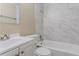 Clean bathroom with white vanity, bathtub, and marble-look tile at 2848 Baker Ridge Nw Dr, Atlanta, GA 30318