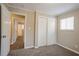 Well-lit bedroom with carpet flooring and double-door closet at 2848 Baker Ridge Nw Dr, Atlanta, GA 30318