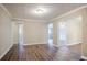 Open dining area with hardwood floors and access to other rooms at 2848 Baker Ridge Nw Dr, Atlanta, GA 30318