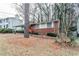 Brick ranch home with red door and mature trees surrounding at 2848 Baker Ridge Nw Dr, Atlanta, GA 30318