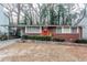 Brick ranch home with red door, landscaping, and a driveway at 2848 Baker Ridge Nw Dr, Atlanta, GA 30318