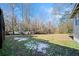 Large backyard with mature trees and patchy snow at 2131 Ben Hill Rd, Atlanta, GA 30344