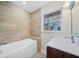 Updated bathroom with a new vanity and tile shower/tub combo at 2131 Ben Hill Rd, Atlanta, GA 30344